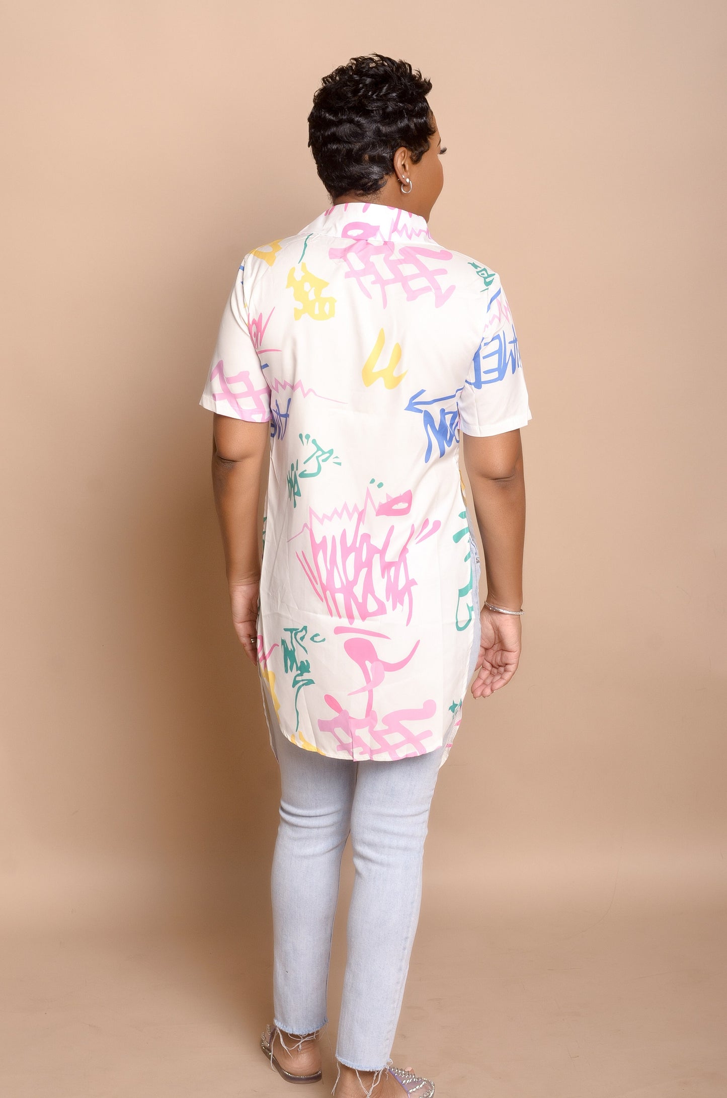 Back side of Graffiti Asymmetrical Top paired with jeans