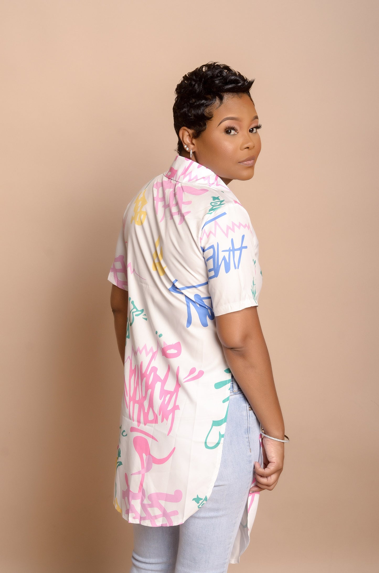 Side post in Graffiti Asymmetrical Top paired with jeans