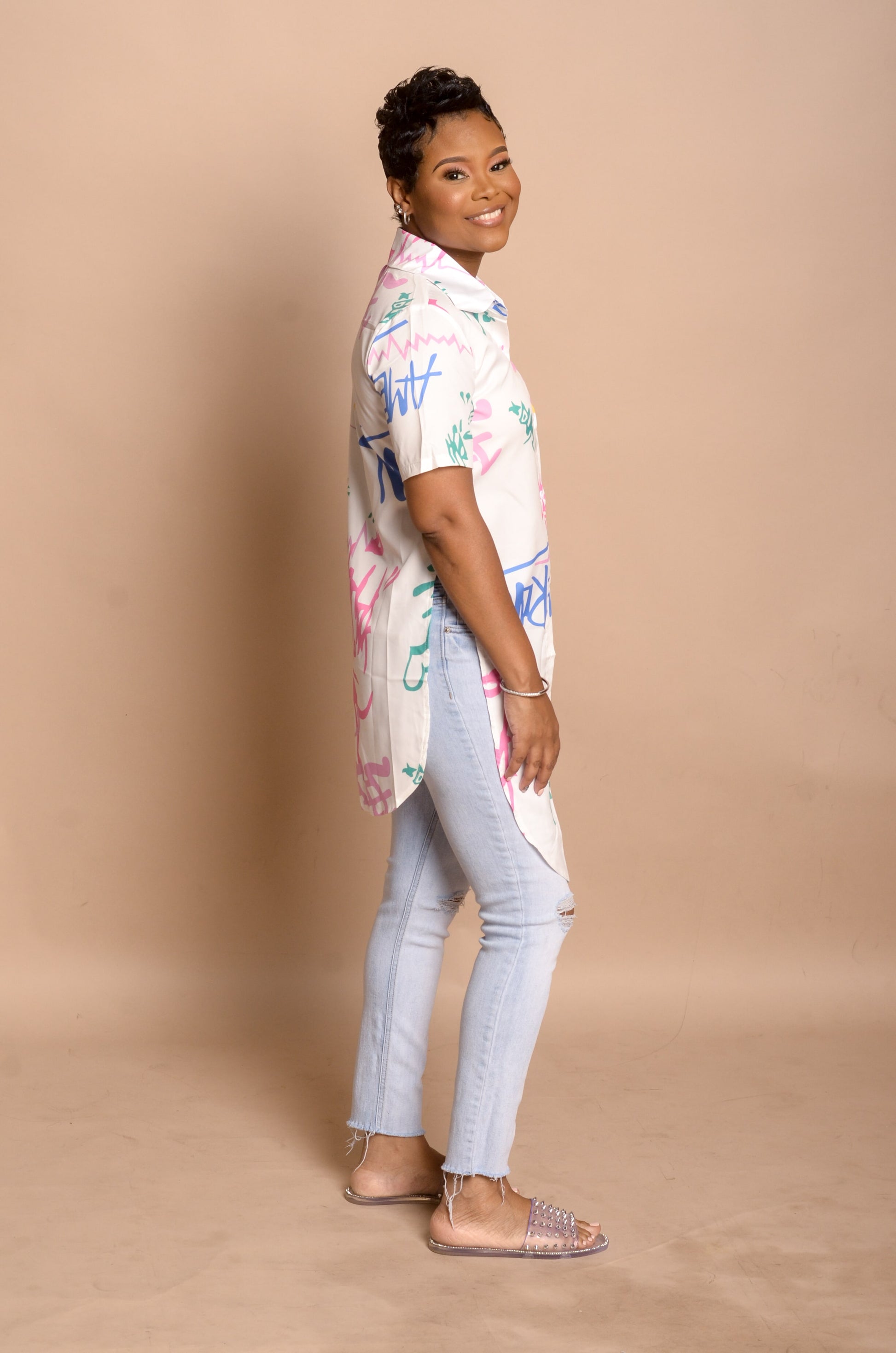 Side view of Graffiti Asymmetrical Top paired with jeans showing long front and short back